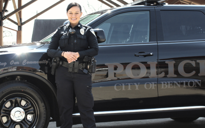 Police officer next to suv